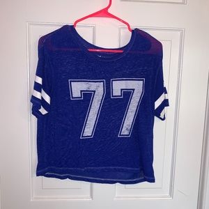 blue shirt with number 77 on it